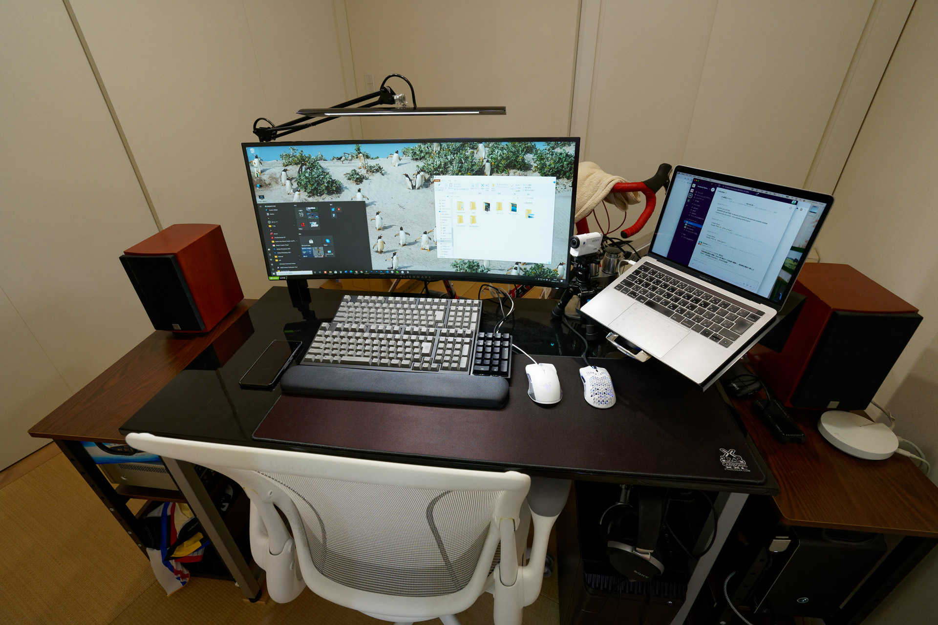 Two desktop PCs and one MacBook Pro connected to a single monitor.